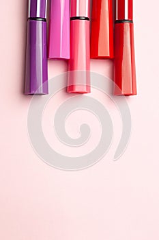 Five markers or pens of pink, purple, pink color lie like prongs on a pink background, isolated mock up