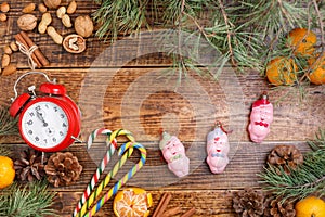 Five minutes before the new year. Cozy background for Christmas and toys pigs.