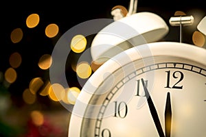 Five minutes to midnight. Midnight countdown to new year. Bokeh and sparks on dark background, new year's eve concept