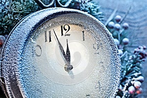 Five minutes to twelve. Snowy Christmas clocks.