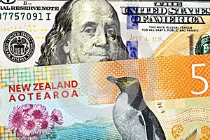 A five New Zealand dollar bill close up with an American one hundred dollar bill