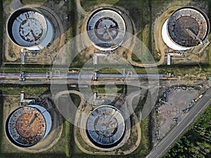 Five oil storage tanks in line top down abstract aerial