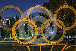 Five olympic rings on the background of the stadium