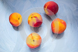 Five peaches at turquoise background