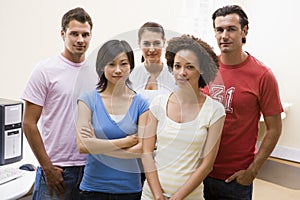 Five people standing in computer room