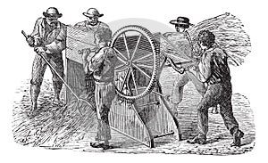 Five people using threshing machine also known as  thrashing machine vintage engraving
