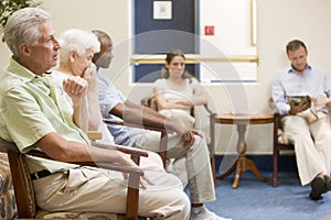 Five people waiting in waiting room photo
