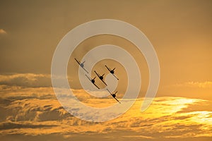 Five planes flying at sunset