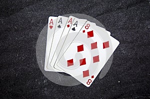 Five playing card`s a hand of a four of a kind ace`s and a eight