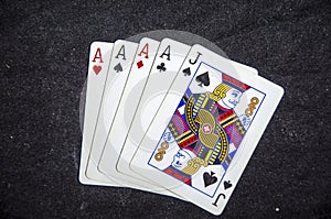 Five playing card`s a hand of a four of a kind ace`s and a jack