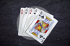 Five playing card`s a hand of a four of a kind ace`s and a king