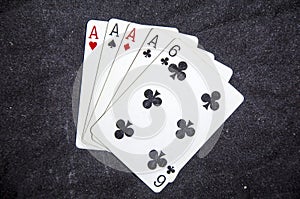 Five playing card`s a hand of a four of a kind ace`s and a six