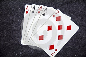 Five playing card`s a hand of a four of a kind ace`s and a six