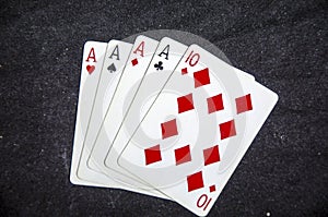 Five playing card`s a hand of a four of a kind ace`s and a ten