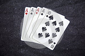 Five playing card`s a hand of a four of a kind ace`s and a ten