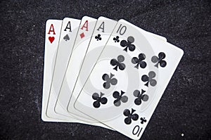 Five playing card`s a hand of a four of a kind ace`s and a ten