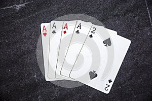 Five playing card`s a hand of a four of a kind ace`s and a two