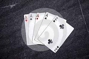 Five playing card`s a hand of a four of a kind ace`s and a two