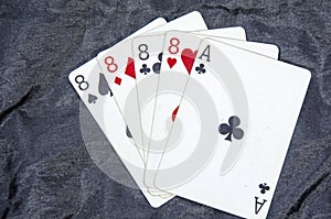Five playing card`s A hand of a four of a kind eight`s and a ace