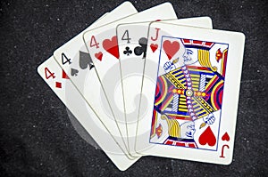 Five playing card`s a hand of a four of a kind four`s and a jack