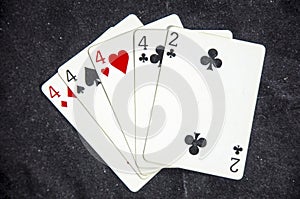 Five playing card`s a hand of a four of a kind four`s and a two