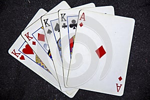 Five playing card`s a hand of a four of a kind king`s and a ace