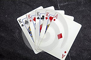 Five playing card`s a hand of a four of a kind king`s and a ace