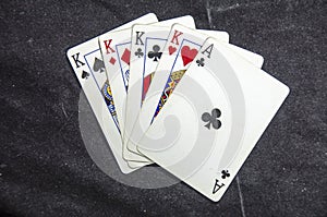 Five playing card`s a hand of a four of a kind king`s and a ace