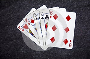 Five playing card`s a hand of a four of a kind king`s and a six