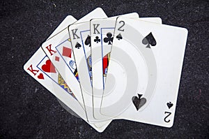 Five playing card`s a hand of a four of a kind king`s and a two