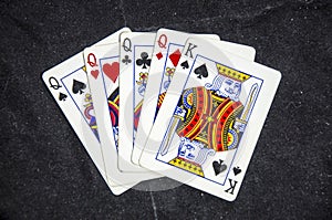 Five playing card`s a hand of a four of a kind queens and a king