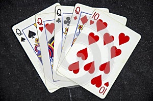 Five playing card`s a hand of a four of a kind queens and a ten