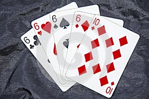 Five playing card`s A hand of a four of a kind six`s and a ten