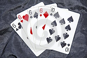 Five playing card`s A hand of a four of a kind six`s and a ten