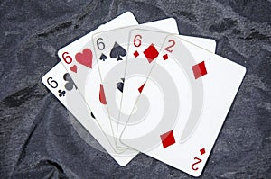 Five playing card`s A hand of a four of a kind six`s and a two