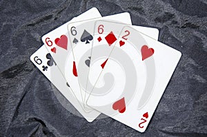 Five playing card`s A hand of a four of a kind six`s and a two