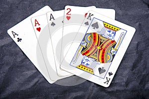 Five playing card`s a hand of a three of a kind ace`s and a two and a king