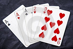 Five playing card`s a hand of a three of a kind ace`s and a two and a nine