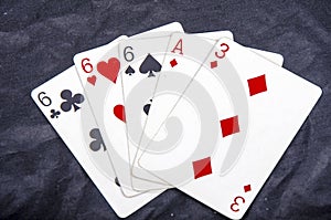 Five playing card`s stud hand three of a kind six and ace a three fun