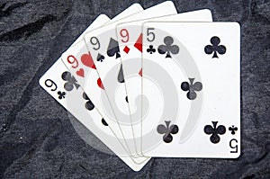 Five playing cards four of a kind nine`s and a five