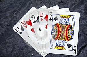 Five playing cards four of a kind ten,s and a king