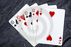 Five playing cards four of a kind ten,s and a two