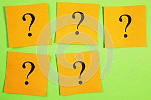 Five Question Marks on Orange on Green Background