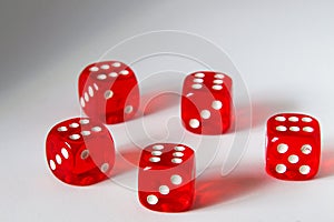 Five red dice on a white background