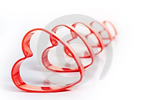 Five red heart 3D shapes sequence isolated white