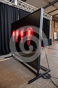 Five red neon bulbs on black LCD screen