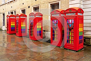 Five red phone boxes on Covent Garden, London, UK