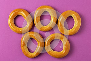 Five round bagels on a pink background. olympic games symbol concept