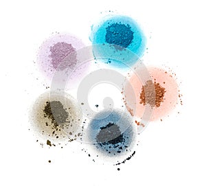 Five samples of bright dry pigment in the form of a flower.