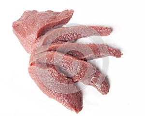 Five slices of raw meat viewed from top